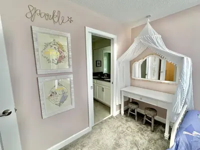a bedroom with a dressing table and a mirror at Amazing 6br w pvt pool game room near Disney in Kissimmee