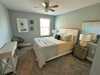 a bedroom with a bed and a ceiling fan at Amazing 6br w pvt pool game room near Disney in Kissimmee
