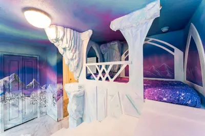 a bedroom with a bed in a room with a ceiling at Amazing 8br w pool theater game room by Disney in Kissimmee