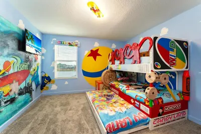 a childs room with a bedroom with a surfboard and a bed at Amazing 8br villa w theme rms game room theater in Kissimmee