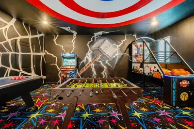 a play room with a foosball table and a mural at Amazing 8br villa w theme rms game room theater in Kissimmee