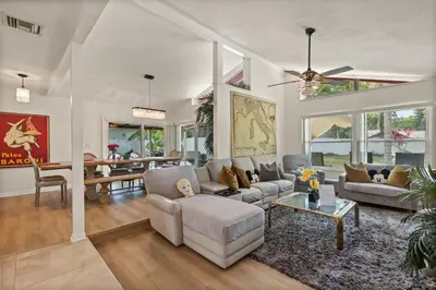 a living room with a couch and a table at Luxury Home, Workspace, Movie Room and BBQ in Kissimmee