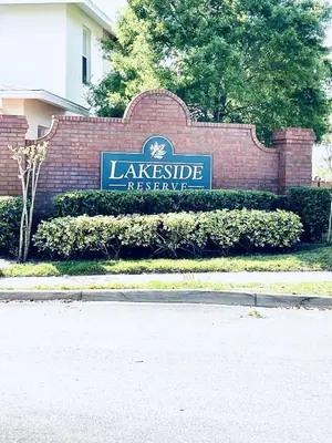 a sign for a lakeside reserve sign on a brick building at Lakeside Community, Pools, And More! in Kissimmee
