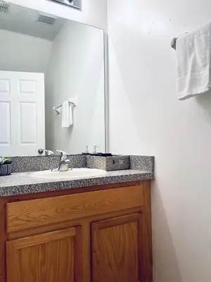 a bathroom with a sink and a mirror at Lakeside Community, Pools, And More! in Kissimmee