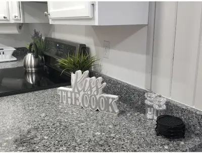 a kitchen counter with a sign that says just hit the cook at Beautiful cottage near Lake Louisa & mins from Disney, Vehicle Rental Available in Clermont