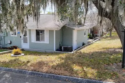 a small house with a tree in front of it at Beautiful cottage near Lake Louisa & mins from Disney, Vehicle Rental Available in Clermont