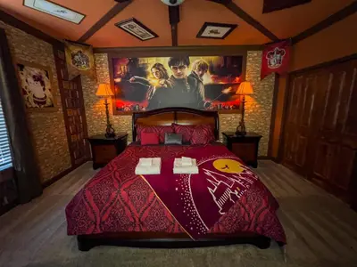 a bedroom with a bed with a movie poster on the wall at 5BR Villa with Game Room and Spa, 12 Min to Disney in Kissimmee