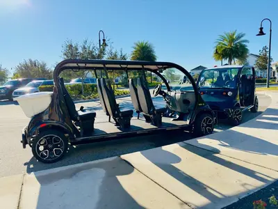 a golf cart parked in a parking lot at 5BR Villa with Game Room and Spa, 12 Min to Disney in Kissimmee