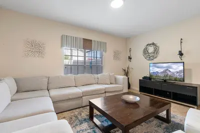 a living room with a couch and a tv at Amazing 5BD and 4BH 6 miles from Disney in Kissimmee