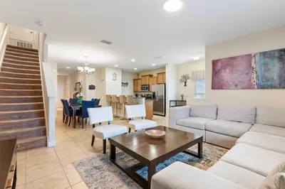 a living room with a couch and a table at Amazing 5BD and 4BH 6 miles from Disney in Kissimmee