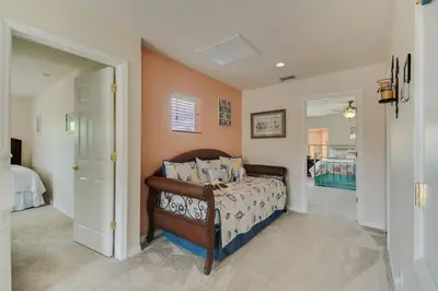 a bedroom with a bed and a hallway with a mirror at Large Pool Deck * All Rooms w/ Private Bathroom in Kissimmee