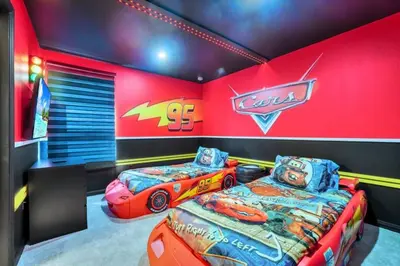 two beds in a room with cars on the wall at Many Themes For Everyone 10 Huge Bedrooms! villa in Kissimmee
