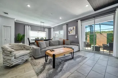 a living room with a couch and a table at Brand New Corner Lot Pond View Vacation Home in Kissimmee