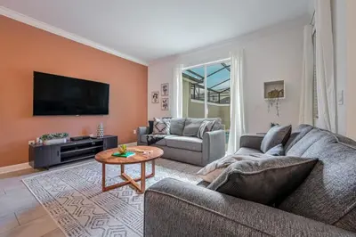 a living room with a couch and a coffee table at Brand new home themed bedrooms prime location in Kissimmee