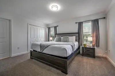 a bedroom with a large bed and a window at Brand new home themed bedrooms prime location in Kissimmee
