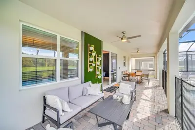 a living room with a couch and a table at 9 Bed Pool Home Storey Lake Resort! home in Kissimmee