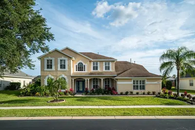 a house on a street with a palm tree at Luxury Villa! Fun in the Sun! Formosa Gardens in Orlando
