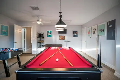 a ping pong table in a room with a pool at Luxury Villa! Fun in the Sun! Formosa Gardens in Orlando