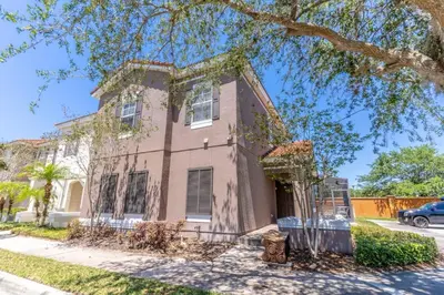 a house on a street with a tree at 4552 Bella Vida 2 in Kissimmee
