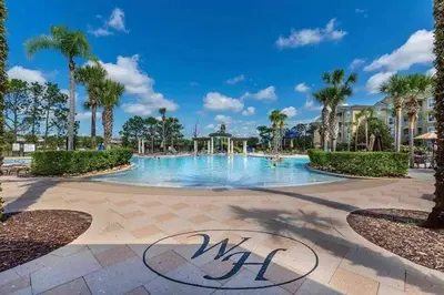 a swimming pool at a resort with palm trees at Minutes to Disney, Free Water Park & Private Pool in Orlando