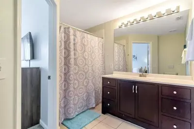 a bathroom with a sink and a large mirror at Minutes to Disney, Free Water Park & Private Pool in Orlando