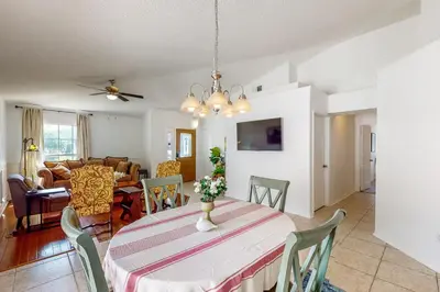a dining room and living room with a table and chairs at Families with Pets! Home Near Orlando Theme Parks in Orlando