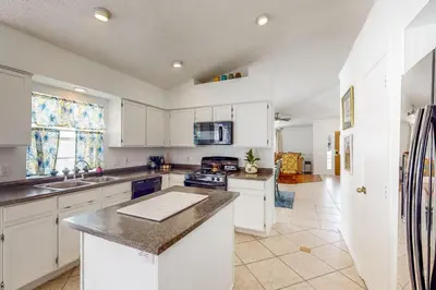 a kitchen with white cabinets and a counter top at Families with Pets! Home Near Orlando Theme Parks in Orlando
