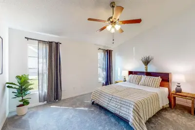 a bedroom with a bed and a ceiling fan at Families with Pets! Home Near Orlando Theme Parks in Orlando