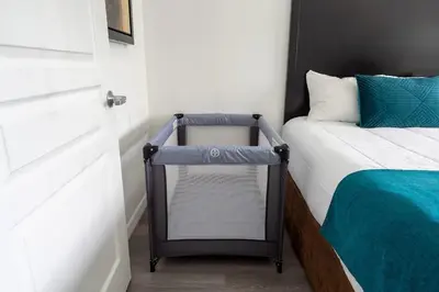 a small bedroom with a bed and a door at 1BR FREE Shuttle to Disney Parks HS305 in Orlando