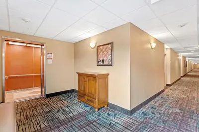 a corridor of a hospital hallway with a wooden cabinet at 1BR FREE Shuttle to Disney Parks HS305 in Orlando