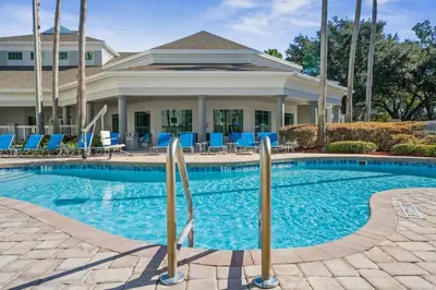 a swimming pool in front of a house at 1BR FREE Shuttle to Disney Parks HS305 in Orlando