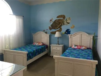 two beds in a childs bedroom with blue walls at #472-Stunning 5 bed property with private south facing deck and pool in Orlando