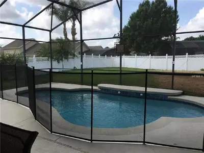 a swimming pool with a fence around it at #472-Stunning 5 bed property with private south facing deck and pool in Orlando