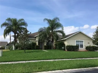 a house with two palm trees in the yard at #472-Stunning 5 bed property with private south facing deck and pool in Orlando