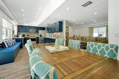 a kitchen and living room with a table and chairs at Private Villa/Outdoor Oasis in Kissimmee