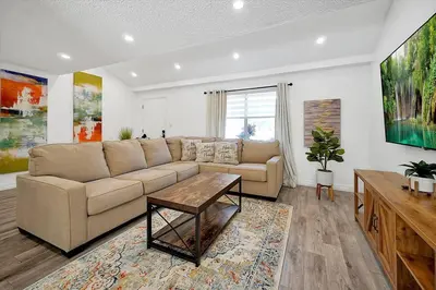 a living room with a couch and a table at Private Villa/Outdoor Oasis in Kissimmee