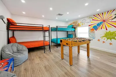 a room with bunk beds and a table with a chessboard at Private Villa/Outdoor Oasis in Kissimmee