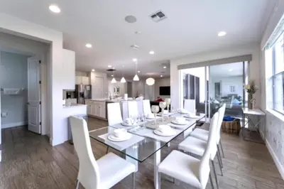 a dining room with a glass table and white chairs at 65 Home At Sonoma Resort, Private Pool, And Much More!! in Kissimmee