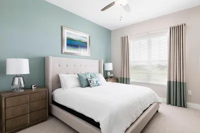 a bedroom with a bed and a window at Gorgeous New 4 Beds DREAM Villa 5 min to Disney in Orlando