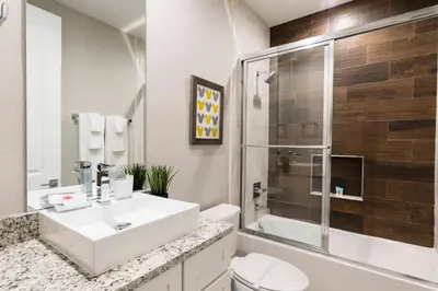 a bathroom with a white sink and a shower at Gorgeous New 4 Beds DREAM Villa 5 min to Disney in Orlando