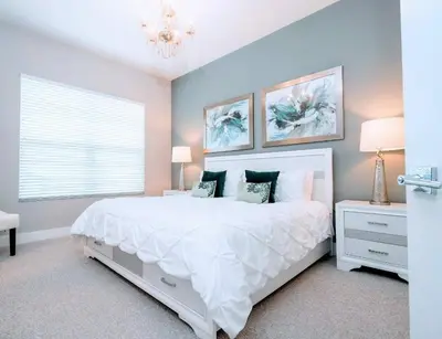 a bedroom with a large white bed and a window at Gorgeous NEW 4 Beds Dream Villa 5 min to Disney in Orlando