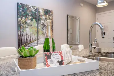 a bottle of wine sitting on a kitchen counter at Gorgeous NEW 4 Beds Dream Villa 5 min to Disney in Orlando