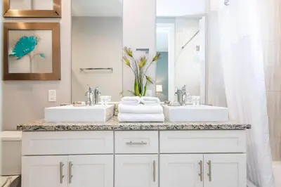 a bathroom with two sinks and a large mirror at Gorgeous NEW 4 Beds Dream Villa 5 min to Disney in Orlando