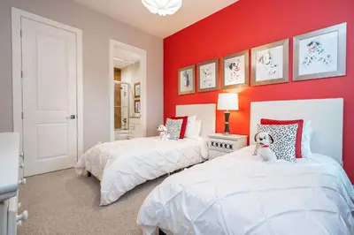 two beds in a room with red walls at Gorgeous NEW 4 Beds Dream Villa 5 min to Disney in Orlando