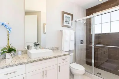 a bathroom with a toilet sink and a shower at 5 Suites DREAM House 5 min to Disney in Orlando