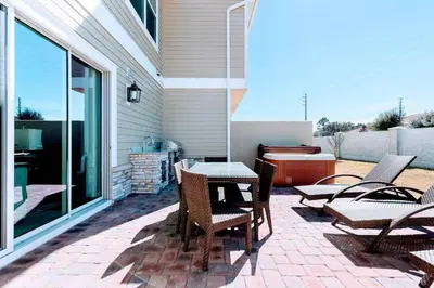 a patio with a table and chairs on a patio at 5 Suites DREAM House 5 min to Disney in Orlando