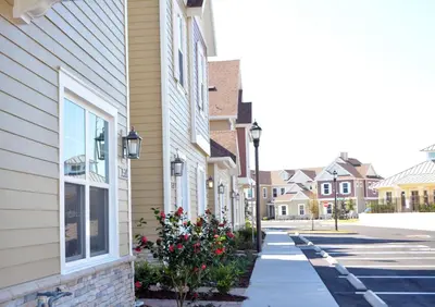 a street in a town with houses and flowers at 5 Suites DREAM House 5 min to Disney in Orlando