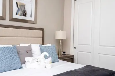 a bedroom with a bed with two swans on it at Dreamscape NEW 4 Suites Villa 5 min to Disney in Orlando