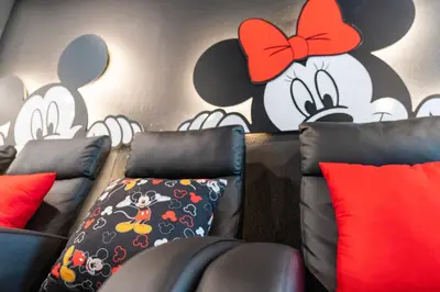 a room with couches and cartoon characters on the wall at New Home 9Bedrooms e 5Bath At Storey Lake in Kissimmee