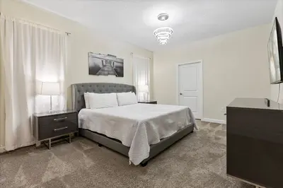 a bedroom with a bed and a television in it at New Home 9Bedrooms e 5Bath At Storey Lake in Kissimmee